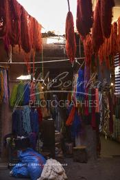 Image du Maroc Professionnelle de  Le Souk des Teinturiers, appelé souk Sebbaghine, l'un des plus pittoresque de Marrakech situé dans la Médina, non loin de la source Mouassine, quelques petits ateliers où l'on pratique encore de nos jours la teinture traditionnelle subsitent. Ce lieu très prisé des touristes et amateurs photos qui désire ardemment des images extrêmement colorées. Avec le temps il est devenu presque une des attractions touristique qui vaut le détour. Face à l’atelier de Si Mohammed Naji des écheveaux de laines sèchent au soleil suspendu en l’air ou le long des murs., le 8 Décembre 2018. (Photo / Abdeljalil Bounhar)